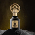 Black bottle gold cap oriental perfume Enta Habibti by Khalifi Perfumes on black sand with dark luminous background